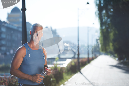 Image of portrait of handsome senior jogging man