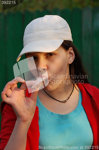 Image of Girl eating roasred meat