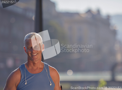 Image of portrait of handsome senior jogging man