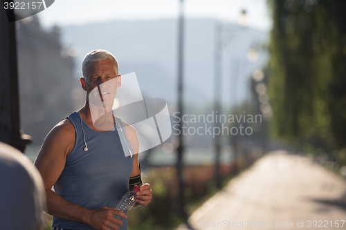 Image of portrait of handsome senior jogging man