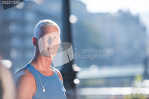 Image of portrait of handsome senior jogging man