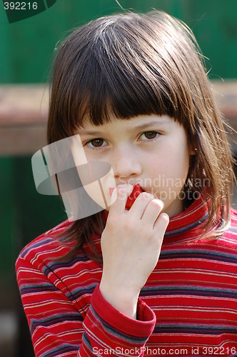 Image of Girl eating red pepper