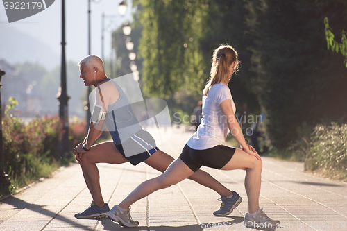 Image of couple warming up and stretching before jogging