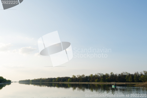 Image of man sails on a boat