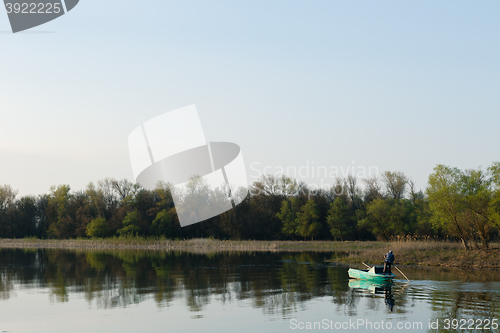 Image of man sails on a boat