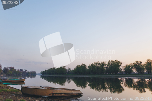 Image of boats moored to the banks of the river