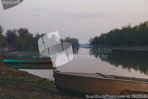 Image of boats moored to the banks of the river