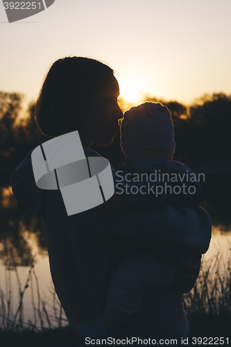 Image of mom with child at sunset