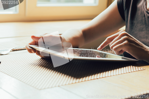 Image of girl works on the tablet