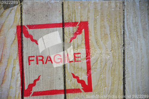 Image of Fragile stenciled on shipping packing crate