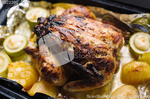 Image of fried chicken on the baking sheet with vegetables