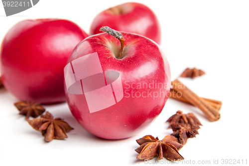 Image of Christmas apples and spices on white background