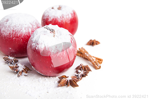 Image of Christmas apples and spices on white background