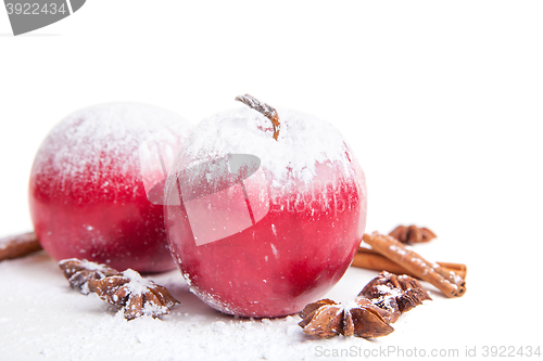 Image of Christmas apples and spices on white background