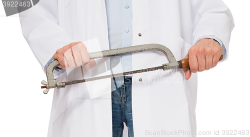 Image of Crazy doctor is holding a big saw in his hands