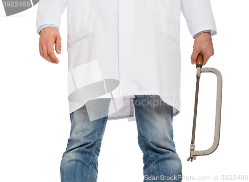 Image of Crazy doctor is holding a big saw in his hands