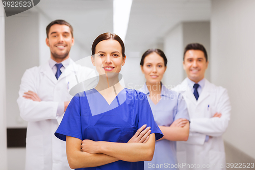 Image of happy group of medics or doctors at hospital