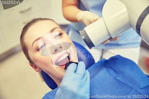 Image of female patient face with x-ray machine and shield