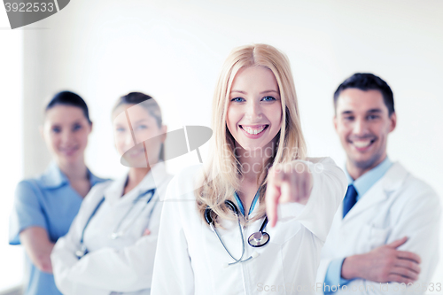 Image of female doctor in front of medical group