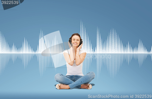 Image of smiling young woman or teen girl in headphones