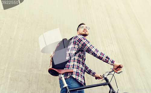 Image of hipster man with fixed gear bike and backpack