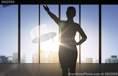 Image of silhouette of business woman pointing hand