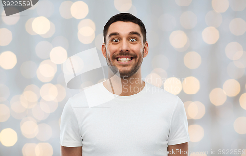 Image of man with funny face over lights background