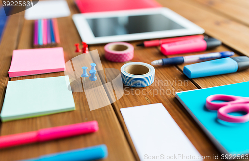 Image of close up of school supplies and tablet pc