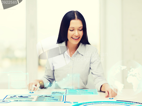 Image of smiling woman pointing to graphs imaginary