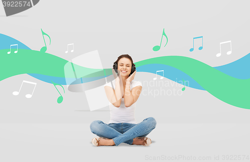 Image of smiling young woman or teen girl in headphones