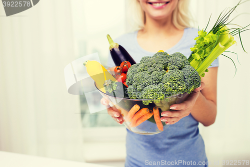 Image of close up of woman holding vegetables in bowl