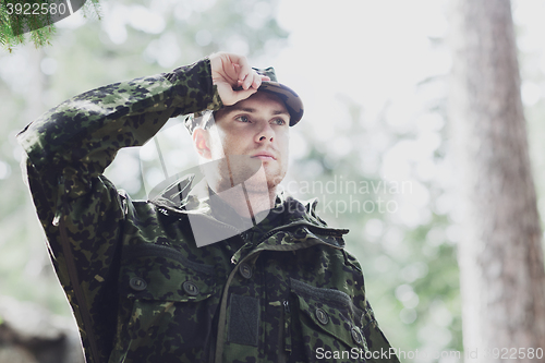 Image of young soldier or ranger in forest