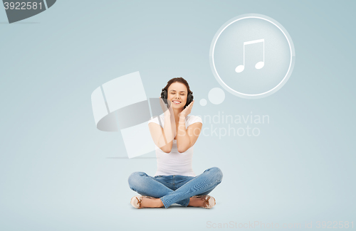 Image of smiling young woman or teen girl in headphones