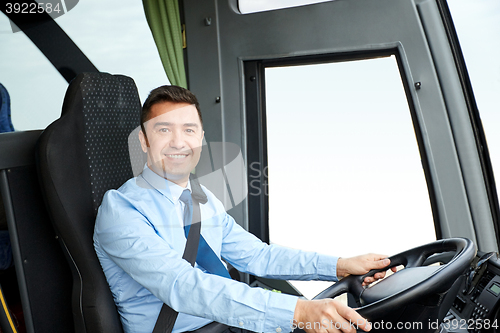 Image of happy driver driving intercity bus