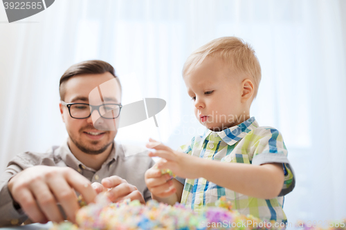 Image of father and son playing with ball clay at home