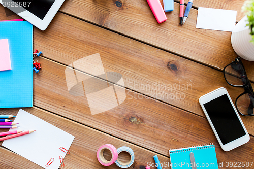 Image of close up of stationery and smartphone on table