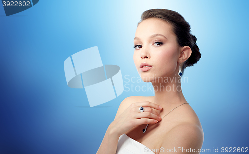 Image of beautiful woman with earring, ring and pendant