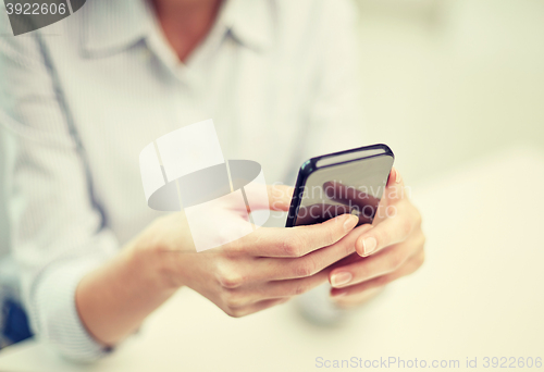 Image of close up of woman texting on smartphone at office