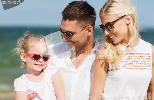 Image of happy family in sunglasses on summer beach