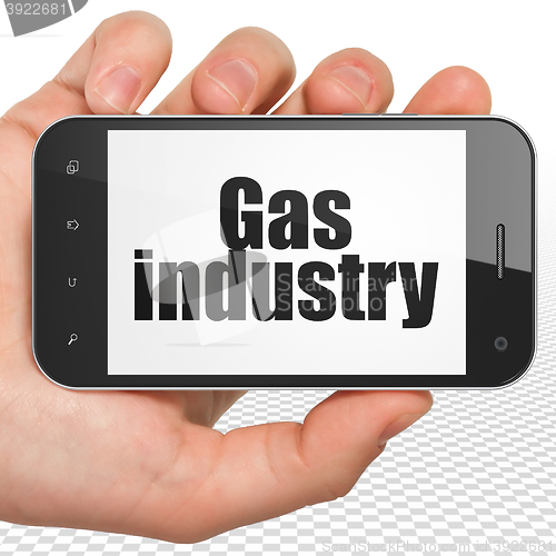 Image of Manufacuring concept: Hand Holding Smartphone with Gas Industry on display