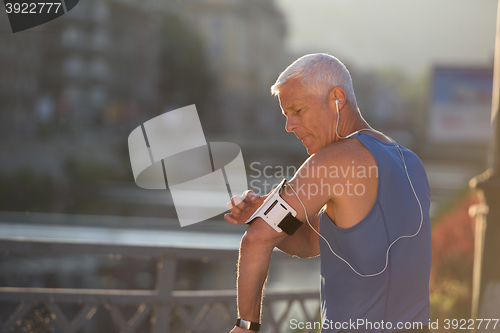 Image of portrait of handsome senior jogging man