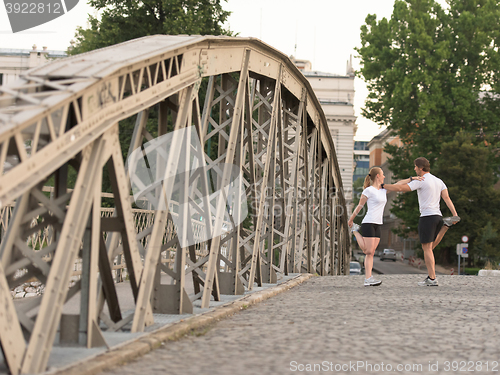 Image of couple warming up and stretching before jogging