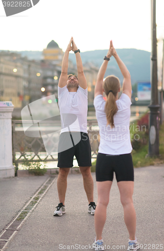 Image of couple warming up before jogging