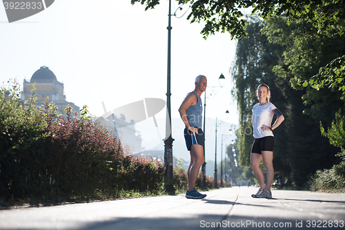 Image of couple warming up and stretching before jogging