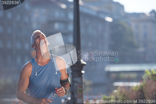 Image of portrait of handsome senior jogging man