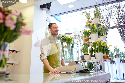 Image of florist man or seller at flower shop counter