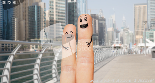 Image of close up of two fingers with smiley faces