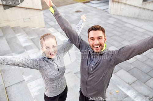 Image of happy smiling couple outdoors on city street