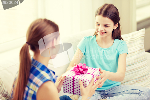 Image of happy little girls with birthday present at home