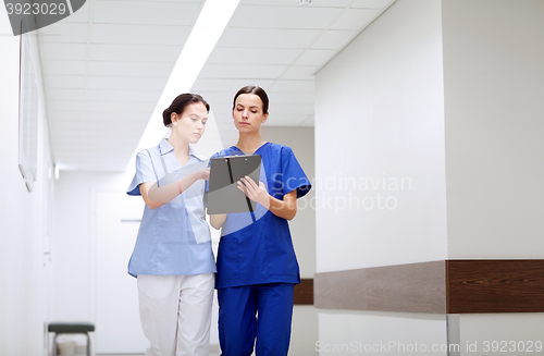 Image of two medics or nurses at hospital with clipboard